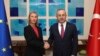 Turkish Foreign Minister Mevlut Cavusoglu, right, shakes hands with the European Union's foreign policy chief Federica Mogherini prior to their meeting, in Ankara, Turkey, Thursday, Nov. 22, 2018. 