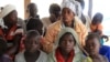 Mothers and children, refugees from from Democratic Republic of Congo, wait to be registered by UNHCR personnel, in Ntoroko, Uganda, Feb. 17, 2018.