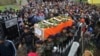 Indian army soldiers carry the body of their colleague Madan Lal Choudhary, who was killed in Saturday's militant attack on Indian army camp, during his funeral at village Bakrak, in Hiranagar, district Kathua, south of Jammu, India, Feb.12, 2018. 