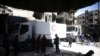 People are seen around Red Crescent aid truck in the besieged town of Douma, Eastern Ghouta, in Damascus, Syria, March 9, 2018.