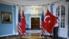 A State Department staffer adjusts a Turkish flag before a meeting between U.S. Secretary of State Mike Pompeo and Turkish Foreign Minister Mevlut Cavusoglu, at the U.S. Department of State in Washington, April 3, 2019.