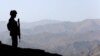 FILE - A Pakistani soldier stands guard along the border fence outside the Kitton outpost on the border with Afghanistan, in North Waziristan, Pakistan Oct. 18, 2017.