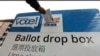 FILE - Voters drop off ballots in the Washington state primary, in Seattle, March 10, 2020.