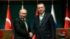 Turkey's President Recep Tayyip Erdogan, right, shakes hands with Russia's President Vladimir Putin, left, following their joint news statement after their meeting at the Presidential Palace in Ankara, Dec. 11, 2017. 