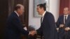 Greek Prime Minister Alexis Tsipras, center, welcomes U.S. Commerce Secretary Wilbur Ross, left, during their meeting in the northern port city of Thessaloniki, Greece, Sept. 7, 2018.