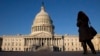 FILE - A woman looks at the U.S. Capitol in Washington. 