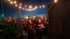 Attendees comfort each other at a candlelight vigil for the victims of the shooting at Marjory Stoneman Douglas High School, Feb. 15, 2018, in Parkland, Fla. 