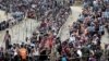 Rohingya refugees queue for aid at Cox's Bazar, Bangladesh, Sept. 26, 2017. 