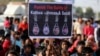 People hold placards at a protest against the rape of an eight-year-old girl, in Kathua, near Jammu, a teenager in Unnao, Uttar Pradesh state, and an eleven-year-old girl in Surat, in Ahmedabad, India, April 22, 2018.