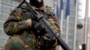 FILE - As a sign of increased security, a Belgian soldier patrols in front of European Union headquarters in Brussels, Jan. 19, 2015. 