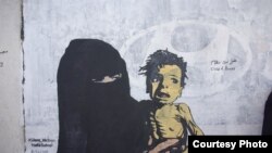 FILE - The mural named "A Boy of Bones" by Yemeni artist Haifa Subay warns of the risk of famine, which is threatening the lives of millions of children, Sanaa, Yemen, Feb. 21, 2019.