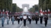 Japanese troops parade on the Champs Elysees avenue during a rehearsal for Bastille Day, early Wednesday, July 11, 2018, in Paris. Japanese and Singapore soldiers will take part in the annual Bastille Day next Saturday. 
