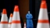 FILE - Health care workers wait for patients to be tested at a walk-in COVID-19 testing site in Arlington, Virginia, May 12, 2020.