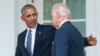 FILE - Then-President Barack Obama, accompanied by then-Vice President Joe Biden, walks back to the Oval Office after speaking in the Rose Garden of the White House, in Washington, Nov. 9, 2016.