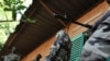 Soldiers stand guard outside the office of Salou Djibo, leader of the coup that overthrew Niger's president Mamadou Tandja in Niamey, 21 Feb 2010
