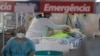 Health workers treat a COVID-19 patient at the emergency unit of a field hospital set up to treat COVID patients in Ribeirao Pires, greater Sao Paulo area, Brazil, April 13, 2021.