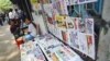 A girl selling weekly journals waits for customers in Rangoon, Burma, April 2, 2012. 