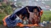 Rohingya refugees shelter from the rain in a camp in Cox's Bazar, Bangladesh, Sept. 17, 2017.