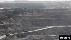 Trucks are seen at a copper mine in Sarlingyi township, Burma, Dec. 14, 2012. 