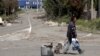 FILE - A man with a cart walks in a street in rebel-controlled city of Donetsk, Ukraine, July 18, 2015. Nearly 1.6 million internally displaced people in rebel-held parts of eastern Ukraine lack access to basic services and benefits, the U.N. refugee agency says.