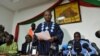 Opposition leader Jean Hubert Bazie (C) reads a statement, next to the head of Burkina Faso's opposition Zephirin Diabre (D), during a press conference on Nov. 1, 2014 in Ouagadougou. 