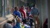 People line up outside Kentucky Career Center prior to its opening to find assistance with their unemployment claims in Frankfort, Kentucky, June 18, 2020.