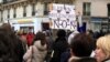 A marcher brandishes a sign against both far-right leader Marine Le Pen and far-left leader Jean-Luc Melenchon, both of whom critics accuse of anti-semitic discourse. 