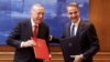 Greek Prime Minister Kyriakos Mitsotakis, right, and Turkish President Recep Tayyip Erdogan smile after signing a joint declaration to pursue good relations, at the Maximos Mansion in Athens, Greece, on Dec. 7, 2023. (Greek Prime Minister’s Office via Reuters)