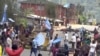 A still image taken from a video shot on October 1, 2017, shows protesters waving Ambazonian flags in front of road block in the English-speaking city of Bamenda, Cameroon. 
