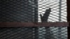 FILE - A defendant, caged in a courtroom, raises his hand, in Torah prison, southern Cairo, Egypt, Aug. 22, 2015. The U.N. has condemned the recent execution in Egypt of 20 men on alleged terrorist-related charges.