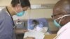 A doctor (left) and a nurse discuss the condition of a patient infected with both HIV and tuberculosis in a hospital in South Africa 