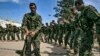 Fighters of the U.S.-backed Kurdish-led Syrian Democratic Forces (SDF) dance as they celebrate near the Omar oil field in the eastern Syria, March 23, 2019, after announcing the total elimination of the Islamic State group's last bastion.