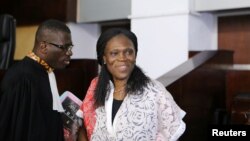 Ivory Coast's former first lady Simone Gbagbo (R), who is accused of crimes against humanity and war crimes for her alleged role in a 2011 civil war, arrives in a domestic court in Abidjan, May 31, 2016.