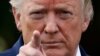 President Donald Trump points to a reporter for a question on the South Lawn of the White House before departing, July 19, 2019, in Washington. 