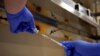 FILE PHOTO: A pharmacist fills a syringe with the Pfizer-BioNTech coronavirus disease (COVID-19) vaccine at Indiana University Health, Methodist Hospital in Indianapolis, Indiana, U.S., December 16, 2020. REUTERS/Bryan Woolston