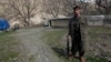 FILE - A Kurdistan Workers' Party (PKK) fighter stands guard at the Qandil mountains near the Iraq-Turkish border in Sulaimaniya, 330 km (205 miles) northeast of Baghdad, March 24, 2013.