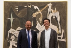 Eskil y Stephane Lam, hijos del pintor surrealista cubano Wifredo Lam, posan para un retrato frente a una obra de arte titulada 'Clarividencia', durante una sesión de fotos para promover una exposición de la obra del artista.