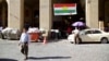 FILE - A man walks past a campaign slogan printed on a Kurdish flag urging people to vote "yes" in the upcoming poll on independence from Iraq, in Irbil, Iraq, Aug. 24, 2017.