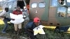 Workers offload food aid from a helicopter in the aftermath of Cyclone Idai, in Buzi, Mozambique, March 25, 2019. 