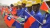 FILE - Students at the vocational training center of reference (Centre de formation professionnelle de reference de Ziniare (CFPR-Z)) in Ziniare, 35kms of Ouagadougou hold Taiwan's and Burkina Faso's flags during the visit of Taiwan's President on April 9