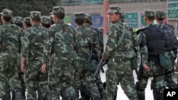 Armed police officers patrol an ethnic Uighur area in Kashgar, Xinjiang province, August 4, 2011.