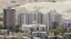 FILE - New buildings are seen in Damascus, where the price of property has been rising sharply.
