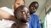 MSF HIV specialist Dr. Eamonn Vitt examines an HIV positive Ugandan woman who's 7 months pregnant. (Nov. 2009)