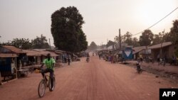 FILE - A man rides a bike in the main avenue of the town of Paoua, northwestern Central African Republic, Dec. 27, 2017. 