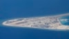 Chinese structures and an airstrip on the man-made Subi Reef at the Spratly group of islands in the South China Sea are seen from a Philippine Air Force C-130 transport plane of the Philippine Air Force, April 21, 2017. The South China Sea issue is expect