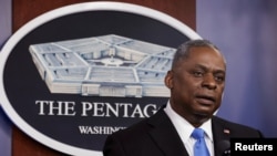 FILE - Defense Secretary Lloyd Austin, pictured speaking to Defense Department personnel at the Pentagon, Feb. 10, 2021, says Washington’s cautious approach in the wake of a rocket attack on an Iraqi air base should not be interpreted as weakness.