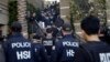 Federal agents enter an upscale apartment complex where authorities say a birth-tourism business charged pregnant women $50,000 for lodging, food and transportation, Irvine, Calif., March 3, 2015.
