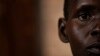 FILE - a South Sudanese refugee and 32-year-old mother, who was raped for several days by a group of soldiers before she was allowed to leave, stands by a window at a women's center.