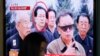 A woman walks past a television showing a report on Jang Song Thaek, North Korean leaders' uncle, at a railway station in Seoul, Dec. 3, 2013. 