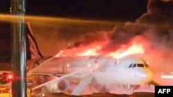 Fire authorities work to extinguish a fire that broke out on an Air Busan passenger plane at Gimhae International Airport in Busan on January 28, 2025. (Photo by YONHAP / AFP)